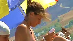 A Cute Girl Sunbathing Nude On The Beach Filmed On A Hidden Cam